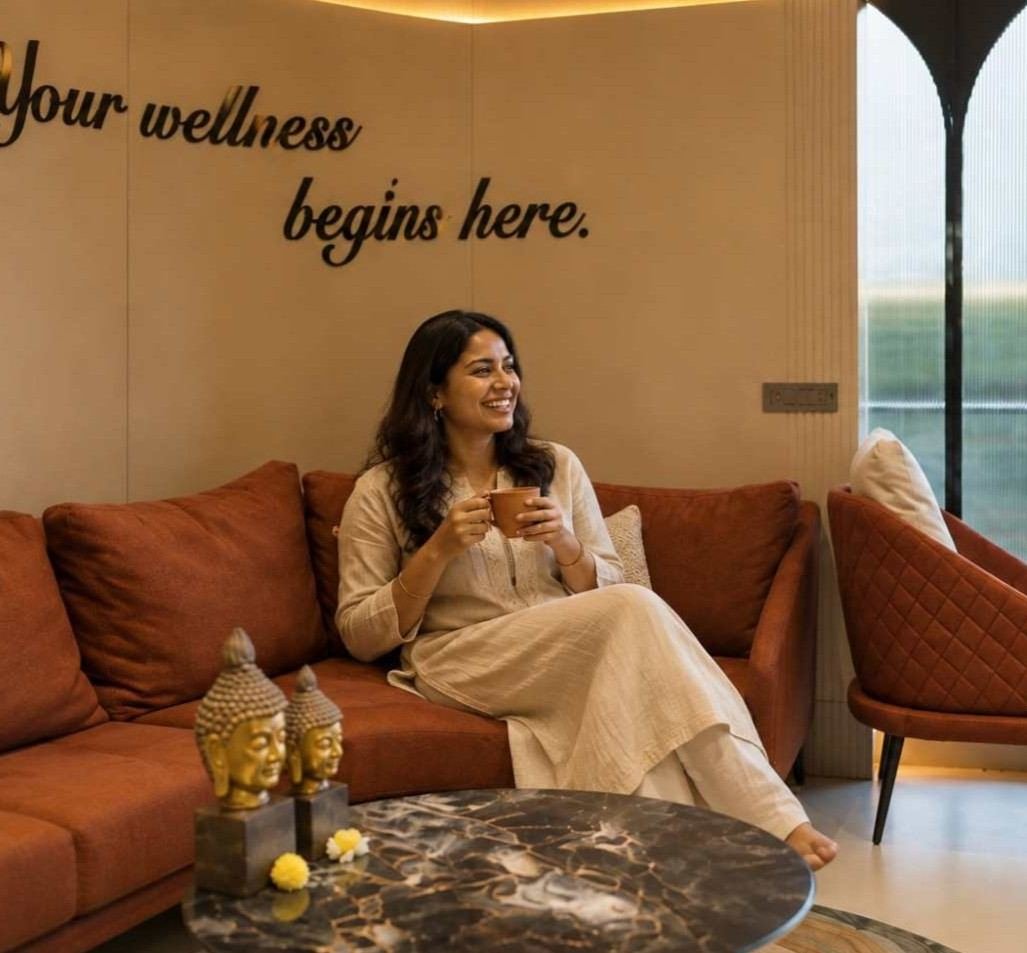 Ananya Sharma resting peacefully with tea in calm architectural spa sanctuary