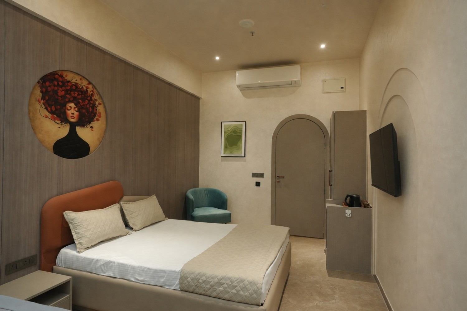 Modern minimalist spa service room with bold architectural artwork and soothing warm lighting